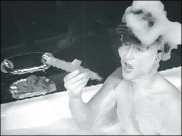 John Lennon in A Hard Day's Night: John plays with his toy battleship while covered with bubbles in the bathtub scene of the Beatles first film.