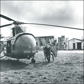 The Beatles in A Hard Day's Night: The Beatles run for the helicopter to make their getaway from their concert.