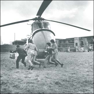 The Beatles in A Hard Day's Night: The Fab Four run for their helicopter to make a getaway in their first feature film.