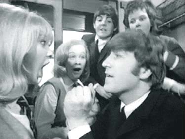 John Lennon in A Hard Day's Night: John startles Patti Boyd in a scene from the Beatles' first feature film.
