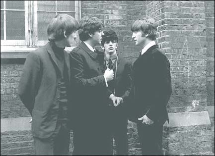 The Beatles in A Hard Day's Night: George Harrison, Paul McCartney, Ringo Starr and John Lennon talk behind the scenes during filming of a pivotal scene in A Hard Day's Night.